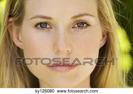 Portrait of young woman looking at the camera, outdoors View Large Photo Image Stock Image - Portrait of young woman looking at the camera, outdoors. Fotosearch