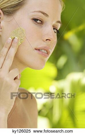 Young woman applying face scrub cream on her face, outdoors View Large Photo Image Stock Photography - Young woman applying face scrub cream on her face, outdoors. Fotosearch
