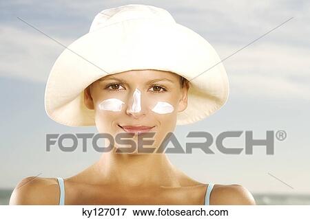 Portrait of a young woman with sun cream on face View Large Photo Image Stock Photo - Portrait of a young woman with sun cream on face. Fotosearch