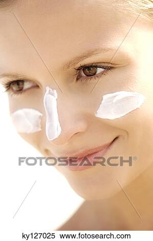 Portrait of a young woman with sun cream on face View Large Photo Image Stock Photography - Portrait of a young woman with sun cream on face. Fotosearch