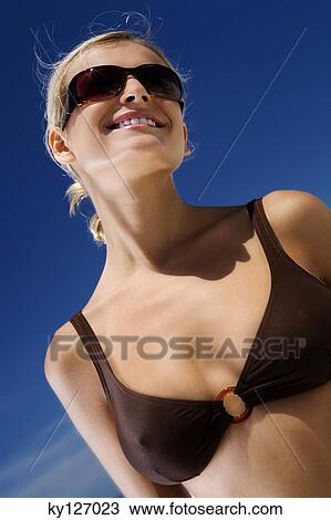 Young smiling woman in bikini on the beach, sunglasses View Large Photo Image Stock Image - Young smiling woman in bikini on the beach, sunglasses. Fotosearch