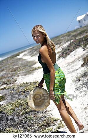 Young smiling woman walking on the beach View Large Photo Image Stock Photography - Young smiling woman walking on the beach. Fotosearch