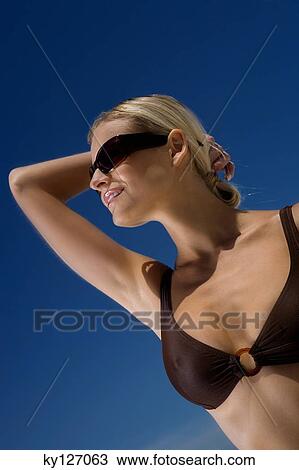 Young woman in bikini on the beach, sunglasses View Large Photo Image Stock Image - Young woman in bikini on the beach, sunglasses. Fotosearch
