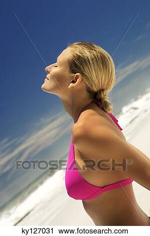 Young woman in pink bikini on beach, head back, eyes closed View Large Photo Image Stock Image - Young woman in pink bikini on beach, head back, eyes closed. Fotosearch