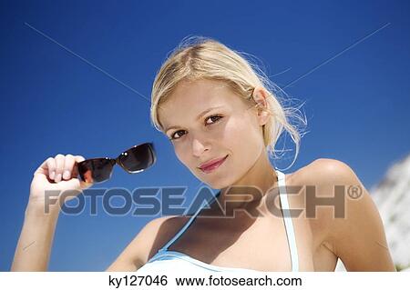 Young woman in swimming costume lying on the beach View Large Photo Image Stock Photograph - Young woman in swimming costume lying on the beach. Fotosearch