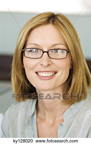 Portrait of a smiling woman with eye glasses View Large Photo Image Stock Image - Portrait of a smiling woman with eye glasses. Fotosearch