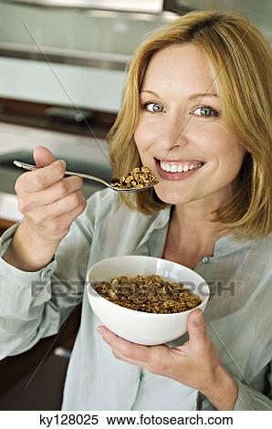 Portrait of a woman eating cereal View Large Photo Image Stock Photography - Portrait of a woman eating cereal. Fotosearch