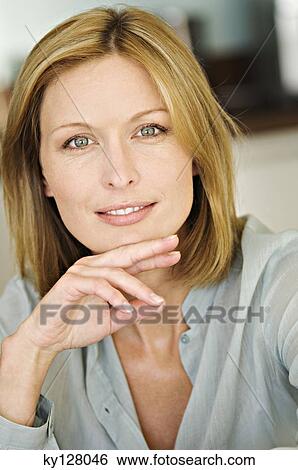 Stock Photograph - Portrait of a woman smiling for the camera. Fotosearch