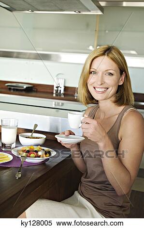Smiling woman having breakfast View Large Photo Image Stock Photography - Smiling woman having breakfast. Fotosearch
