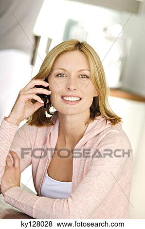 Smiling woman using mobile phone View Large Photo Image Stock Photo - Smiling woman using mobile phone. Fotosearch