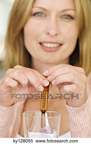 Woman breaking ampoule in a glass View Large Photo Image Stock Photography - Woman breaking ampoule in a glass. Fotosearch