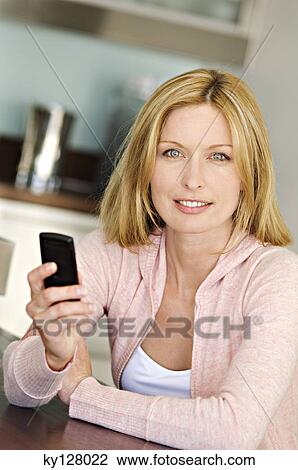 Woman holding mobile phone View Large Photo Image Stock Image - Woman holding mobile phone. Fotosearch
