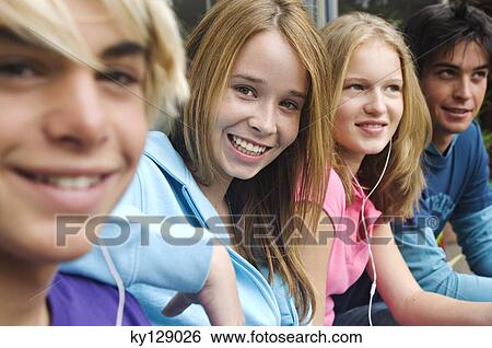 2 teenage boys and 2 teenage girls smiling for camera View Large Photo Image Stock Photograph - 2 teenage boys and 2 teenage girls smiling for camera. Fotosearch
