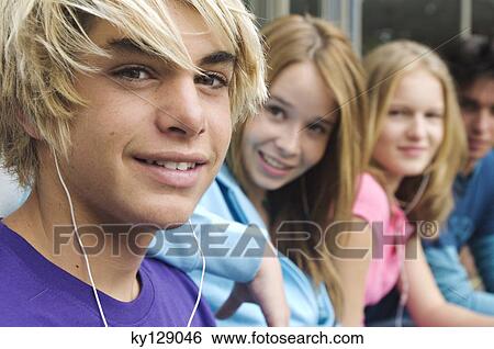 2 teenage boys and 2 teenage girls smiling for camera View Large Photo Image Stock Photograph - 2 teenage boys and 2 teenage girls smiling for camera. Fotosearch