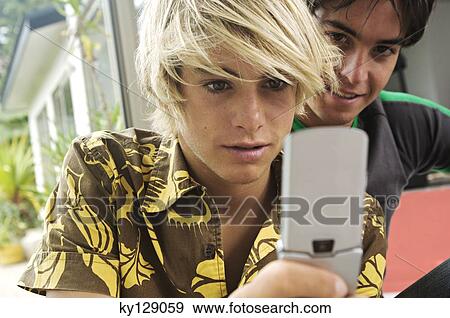 2 teenage boys using mobile phone View Large Photo Image Stock Photo - 2 teenage boys using mobile phone. Fotosearch