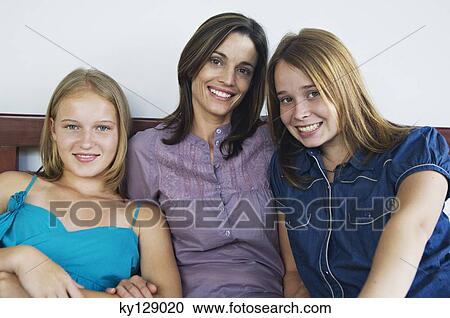 2 teenage girls and a woman smiling for the camera View Large Photo Image Stock Image - 2 teenage girls and a woman smiling for the camera. Fotosearch