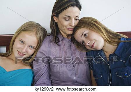 2 teenage girls leaning on woman's shoulders View Large Photo Image Stock Image - 2 teenage girls leaning on woman's shoulders. Fotosearch