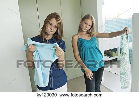 2 teenage girls trying on clothes View Large Photo Image Stock Image - 2 teenage girls trying on clothes. Fotosearch