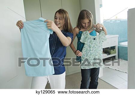 2 teenage girls trying on clothes View Large Photo Image Stock Photography - 2 teenage girls trying on clothes. Fotosearch