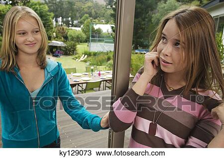 2 teenage girls using mobile phone View Large Photo Image Stock Image - 2 teenage girls using mobile phone. Fotosearch