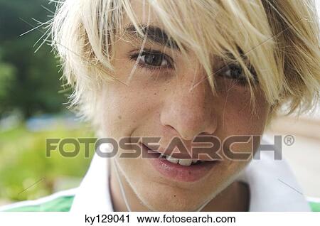 Portrait of a teenage boy looking at the camera View Large Photo Image Stock Image - Portrait of a teenage boy looking at the camera. Fotosearch