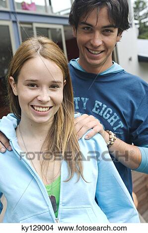 Teenage boy and girl smiling for the camera View Large Photo Image Picture - Teenage boy and girl smiling for the camera. Fotosearch