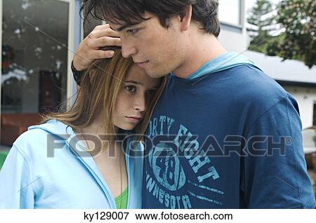 Teenage boy consoling teenage girl View Large Photo Image Stock Photo - Teenage boy consoling teenage girl. Fotosearch