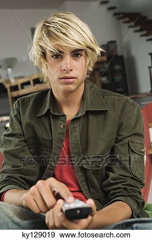 Teenage boy using remote-control View Large Photo Image Stock Photo - Teenage boy using remote-control. Fotosearch