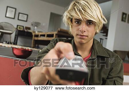 Teenage boy using remote-control View Large Photo Image Stock Photo - Teenage boy using remote-control. Fotosearch