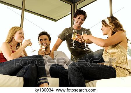 Picture - 2 young couples drinking champagne. Fotosearch