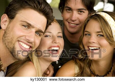 Stock Image - 2 young couples smiling for the camera. Fotosearch
