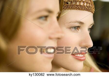 Portrait of 2 young smiling women, view in profile View Large Photo Image Stock Image - Portrait of 2 young smiling women, view in profile. Fotosearch