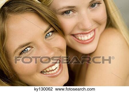 Portrait of 2 young women smiling for the camera View Large Photo Image Stock Image - Portrait of 2 young women smiling for the camera. Fotosearch