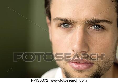 Stock Image - Portrait of a young man looking at the camera. Fotosearch
