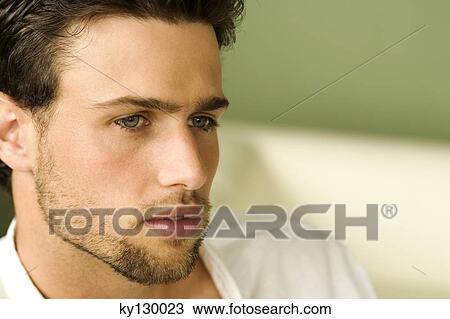 Stock Image - Portrait of a young thinking man. Fotosearch