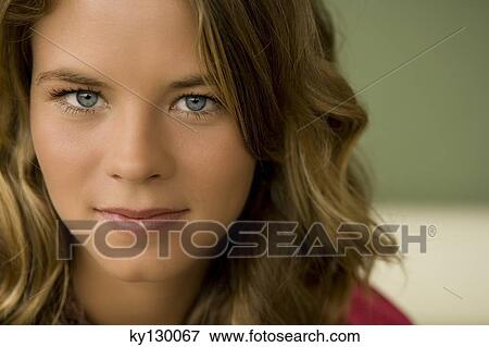 Portrait of a young woman looking at the camera View Large Photo Image Stock Photo - Portrait of a young woman looking at the camera. Fotosearch