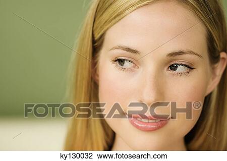 Portrait of a young woman looking away View Large Photo Image Stock Image - Portrait of a young woman looking away. Fotosearch
