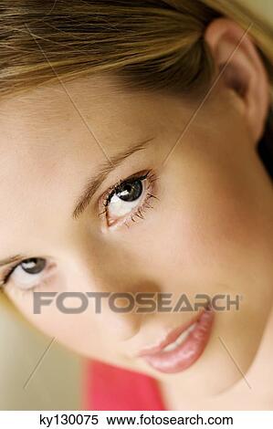 Portrait of young woman looking at the camera View Large Photo Image Stock Photography - Portrait of young woman looking at the camera. Fotosearch