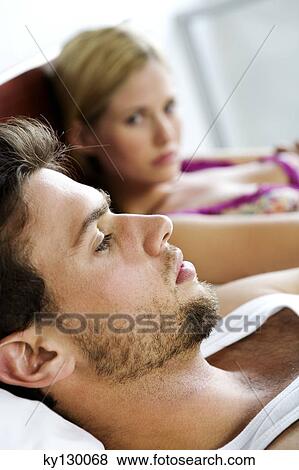Young couple in bed View Large Photo Image Stock Photo - Young couple in bed. Fotosearch