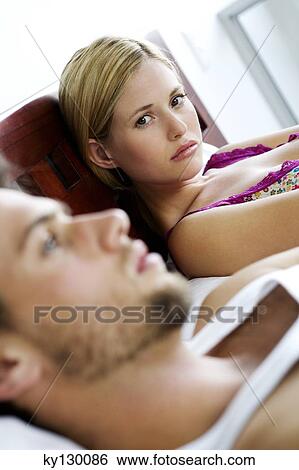 Young couple in bed View Large Photo Image Stock Photograph - Young couple in bed. Fotosearch