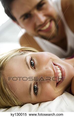 Young smiling couple in bed View Large Photo Image Stock Photography - Young smiling couple in bed. Fotosearch