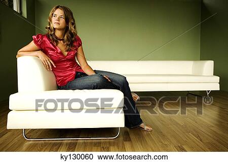 Young thinking woman sitting on a sofa View Large Photo Image Stock Image - Young thinking woman sitting on a sofa. Fotosearch