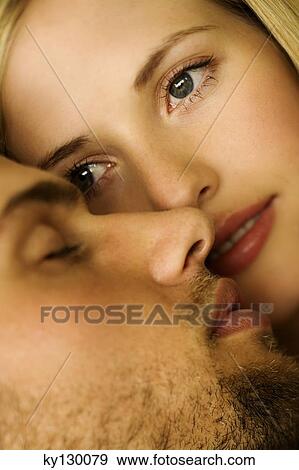Stock Photo - Young woman looking at sleeping man. Fotosearch