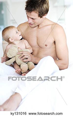 Father and baby sitting indoors View Large Photo Image Stock Photograph - Father and baby sitting indoors. Fotosearch