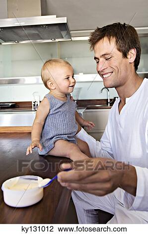 Father and son in kitchen, indoors View Large Photo Image Stock Image - Father and son in kitchen, indoors. Fotosearch
