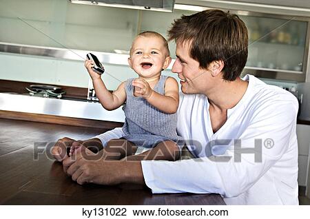 Father and son in kitchen, indoors View Large Photo Image Stock Image - Father and son in kitchen, indoors. Fotosearch