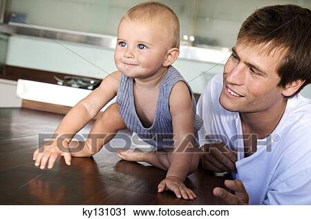 Father and son in kitchen, indoors View Large Photo Image Stock Image - Father and son in kitchen, indoors. Fotosearch
