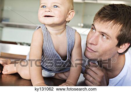 Father and son in kitchen, indoors View Large Photo Image Stock Image - Father and son in kitchen, indoors. Fotosearch