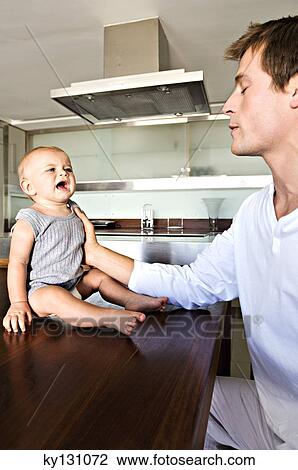 Father and son in kitchen, indoors View Large Photo Image Stock Image - Father and son in kitchen, indoors. Fotosearch
