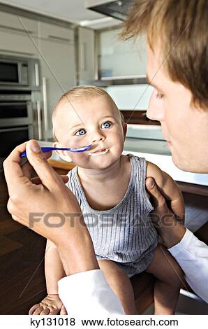 Father and son in kitchen, indoors View Large Photo Image Stock Photo - Father and son in kitchen, indoors. Fotosearch